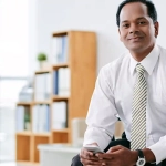 An indian businessman holding phone in hand and planning to Move to Germany from India