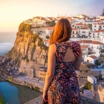 Living in Portugal as an Expat, a woman admiring the sunset at azenhas