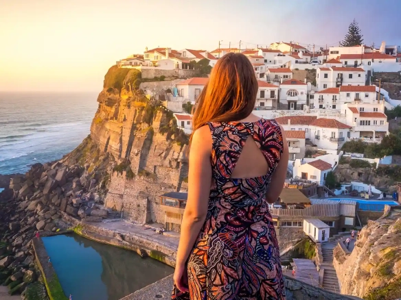 Living in Portugal as an Expat, a woman admiring the sunset at azenhas