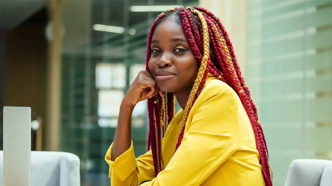 Hopeful Nigerian fashion design student with afro pigtails, preparing to study in Germany from Nigeria