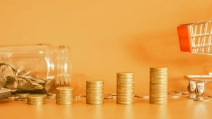 Coin stacks growing beside a tipped jar and shopping cart, visually representing the Average Salary vs Cost of Living in Germany and how expenses increase with income.