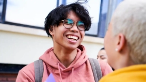 International students smiling and talking on campus at the Best University in Berlin for International Students