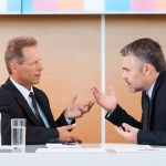 Two businessmen in a heated discussion showing how the German Communication Style Rude dynamic can escalate professional conversations.