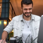 How to Find Remote Jobs in Germany for English Speakers – man working remotely on a laptop from a creative indoor workspace