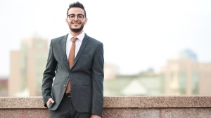 Confident young man in a suit holding a briefcase, representing How to Get a Job in Germany from Morocco as a skilled professional.