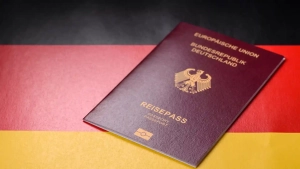 German passport on national flag representing How to Get German Citizenship through naturalization or dual citizenship options