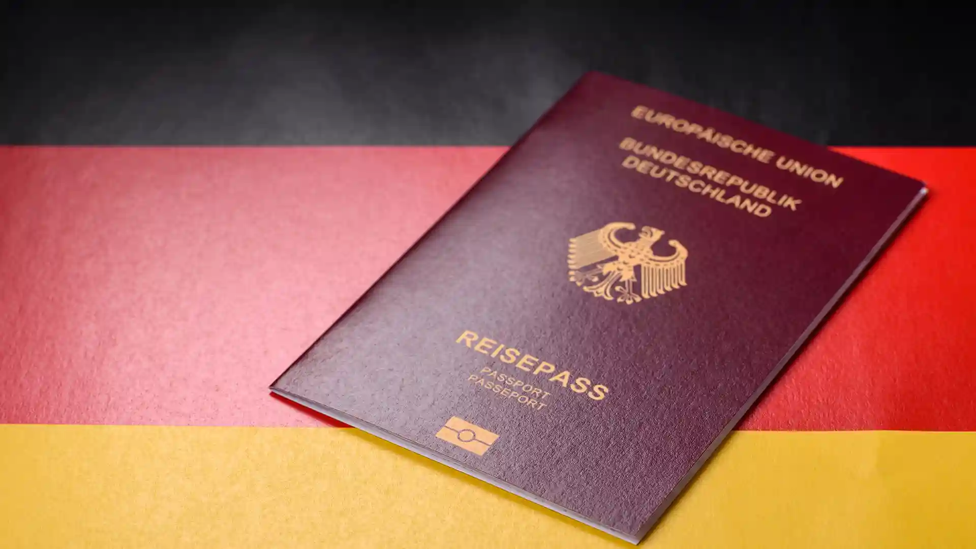 German passport on national flag representing How to Get German Citizenship through naturalization or dual citizenship options