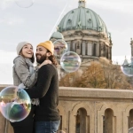Happy American couple in Berlin enjoying their time near Berlin Cathedral – a symbol of new beginnings and jobs in Germany for Americans