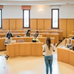 A diverse group of students attending a lecture in a modern German university setting. Ideal visual representation of DAAD Scholarships for International Students supporting global academic exchange and higher education opportunities in Germany.