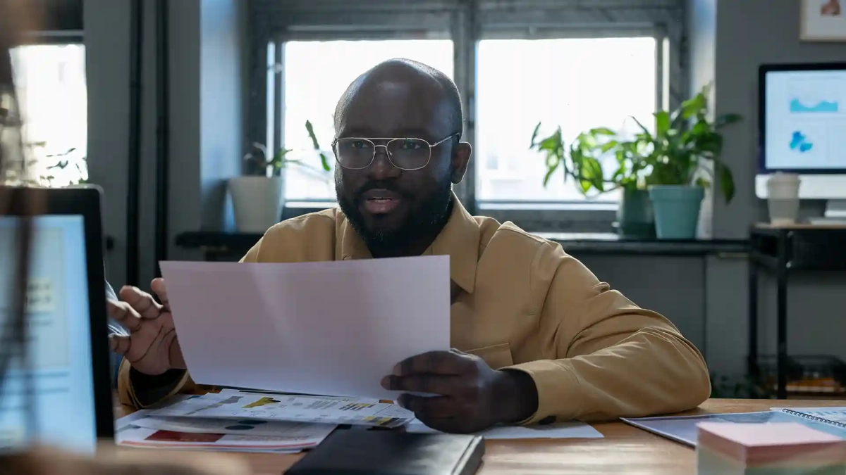 confident african american holding a credit score report in hand showing How to Get SCHUFA for Free