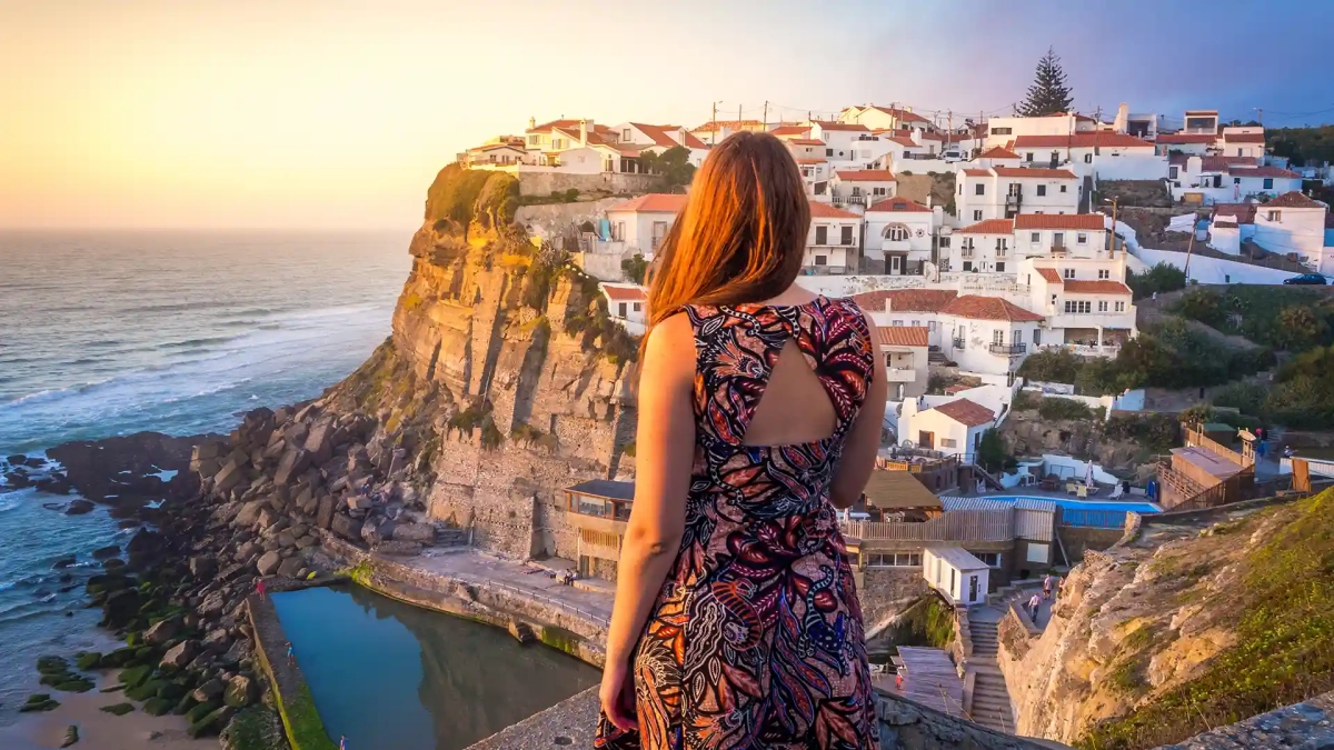Living in Portugal as an Expat, a woman admiring the sunset at azenhas