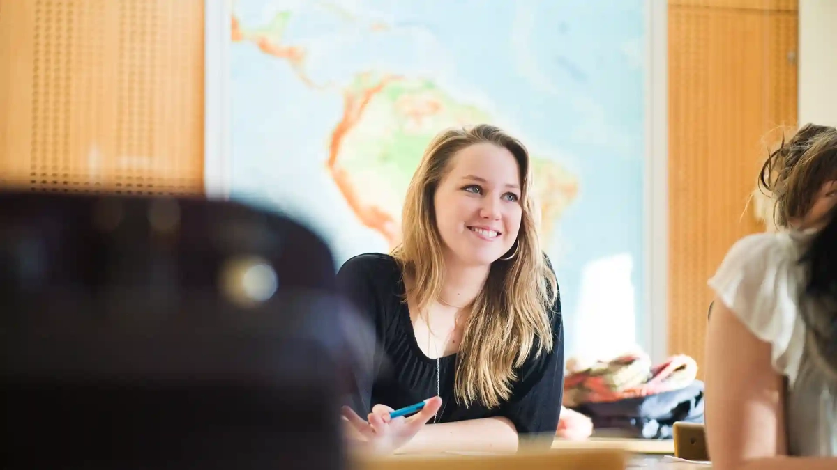 happy Erasmus Programme student sitting at classroom