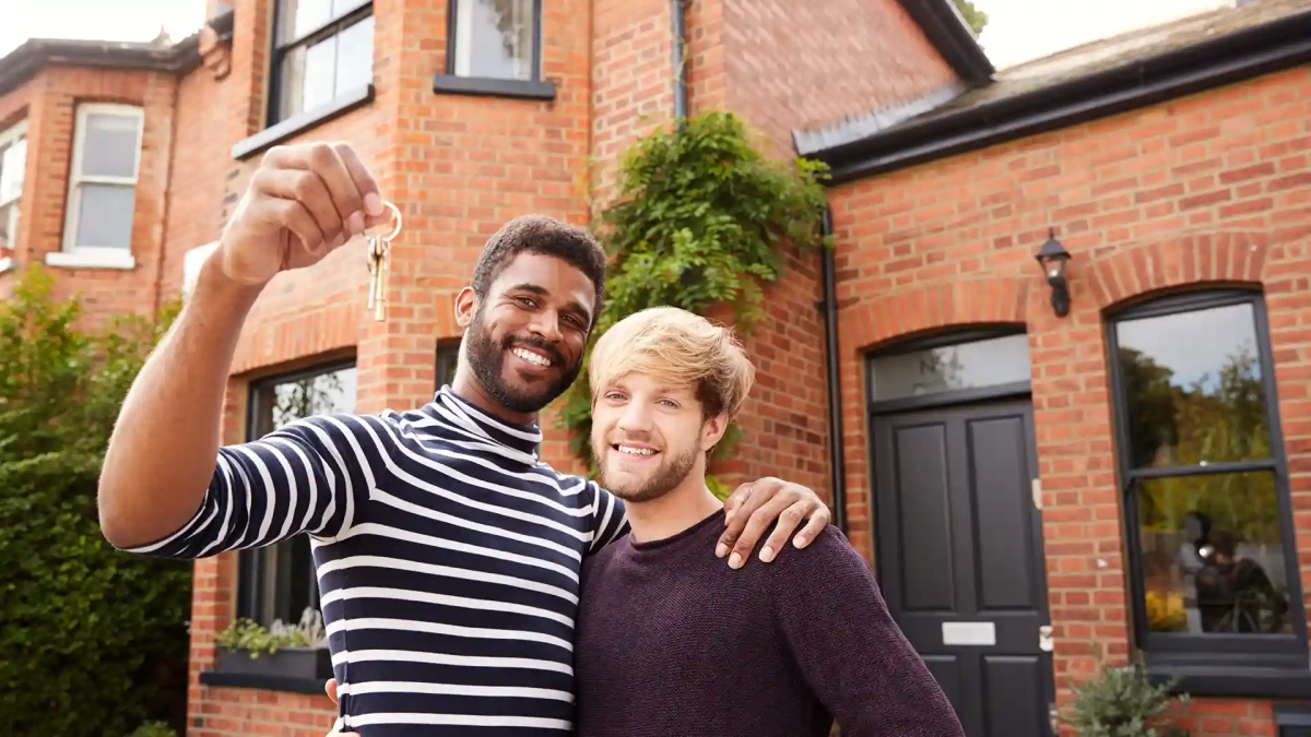 Excited couple standing outside their new home, symbolizing success in the journey of How to Buy Property in Germany as a Foreigner