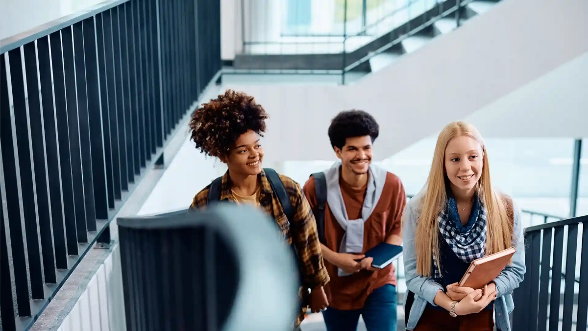 International students walking on a university campus staircase – Tips for Applying to German Universities