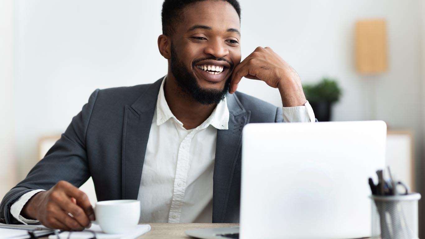 cheerful african american employee sitting at work