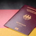 German passport on national flag representing How to Get German Citizenship through naturalization or dual citizenship options