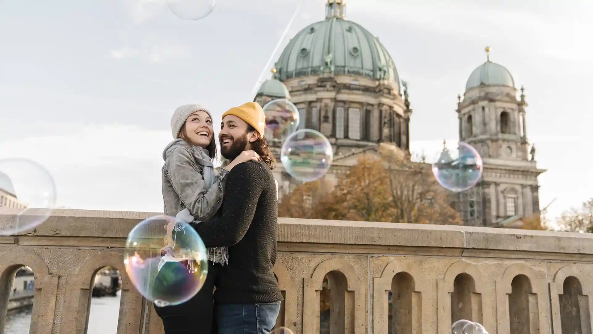 Happy American couple in Berlin enjoying their time near Berlin Cathedral – a symbol of new beginnings and jobs in Germany for Americans