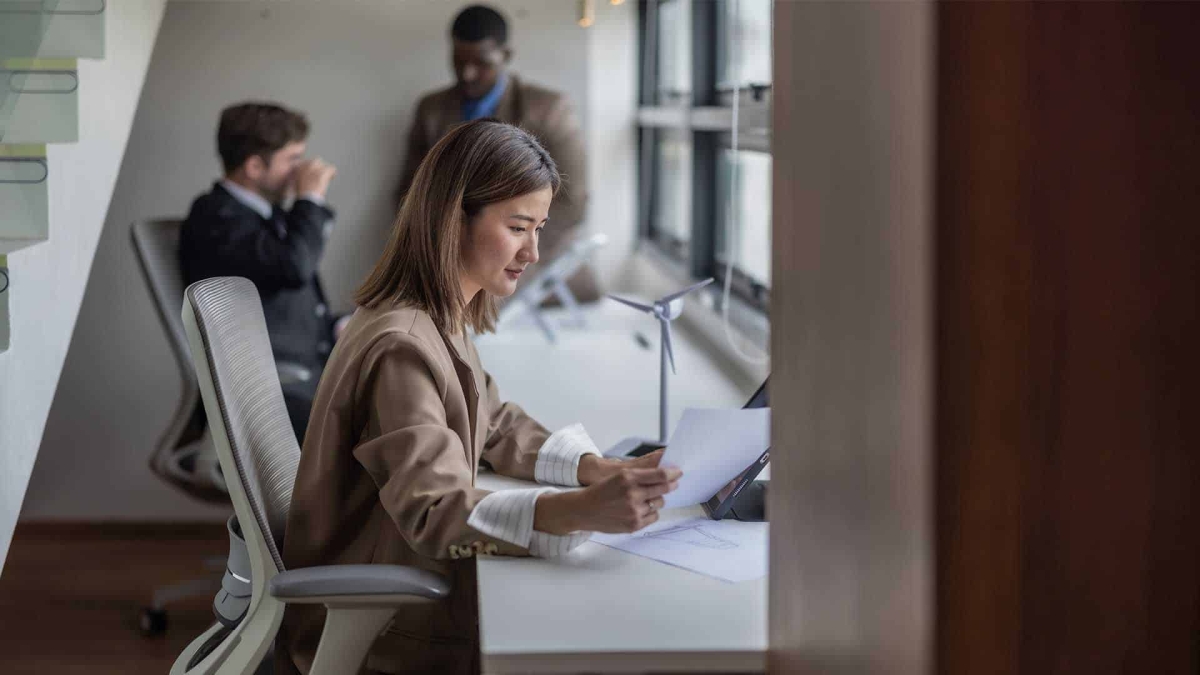 a young female expert in the energy sector is requiring a document that symbolizing reviewing the average salary in germany
